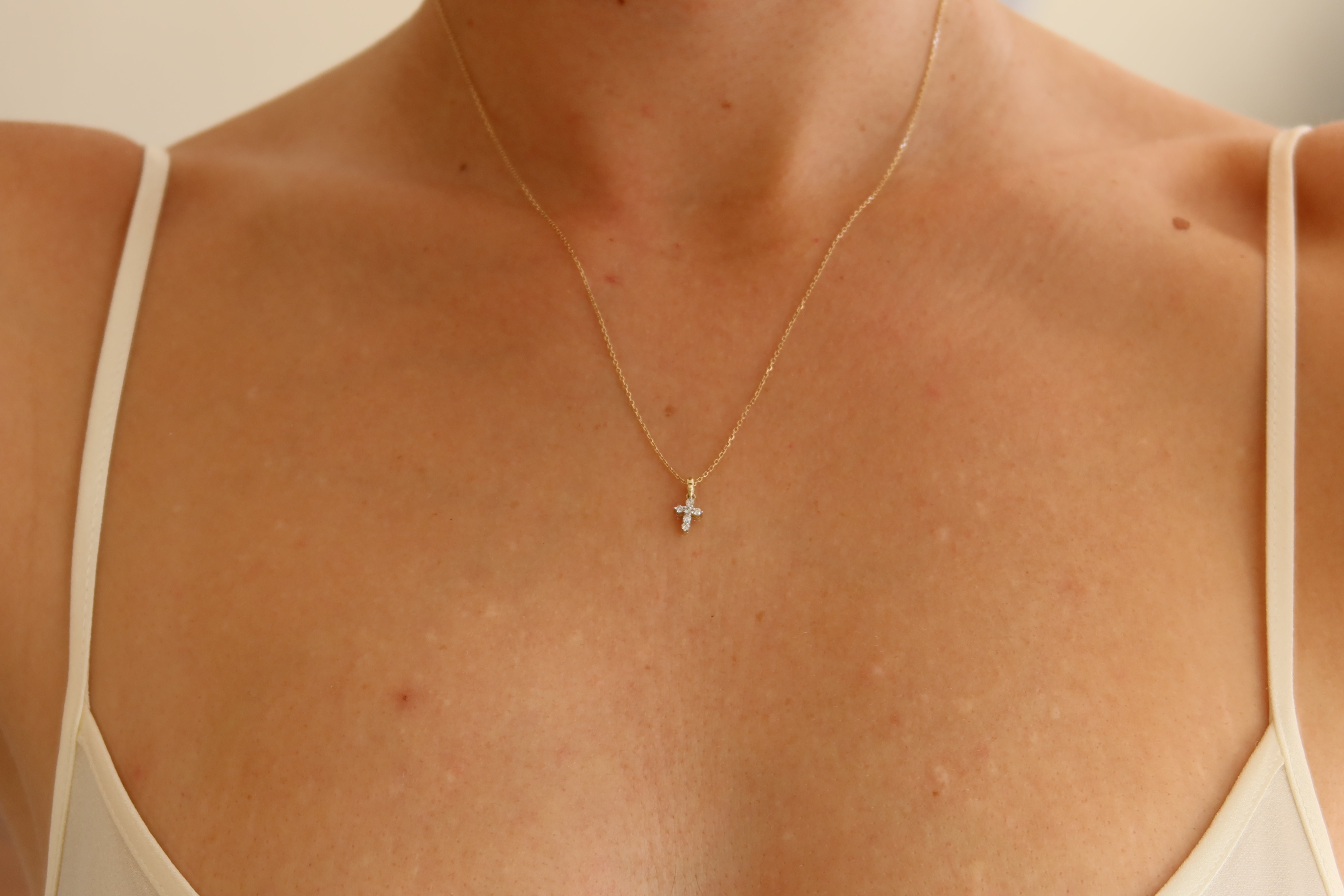 dainty 9 karat yellow gold oval link chain with mini diamond cross pendant