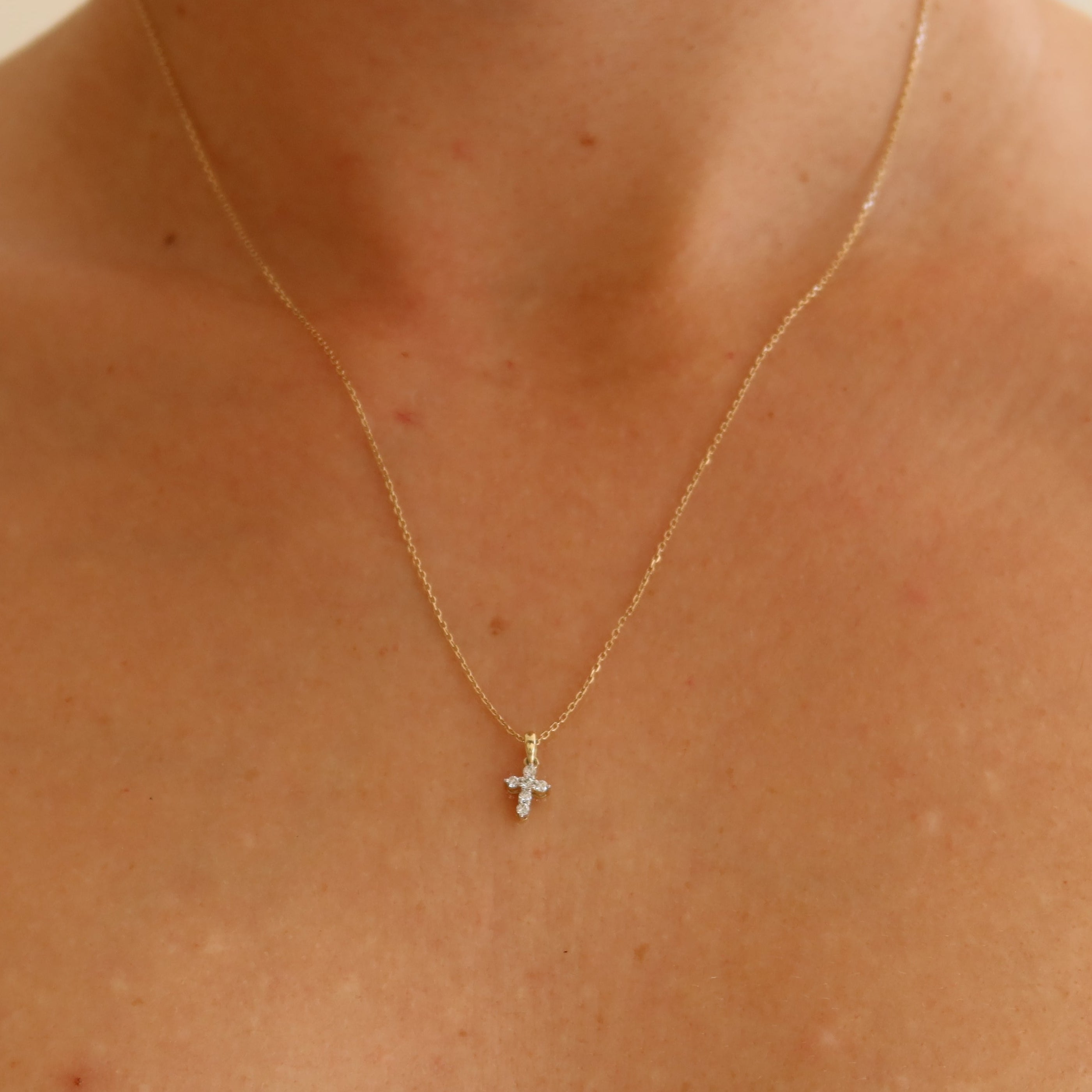 dainty 9 karat yellow gold oval link chain with mini diamond cross pendant