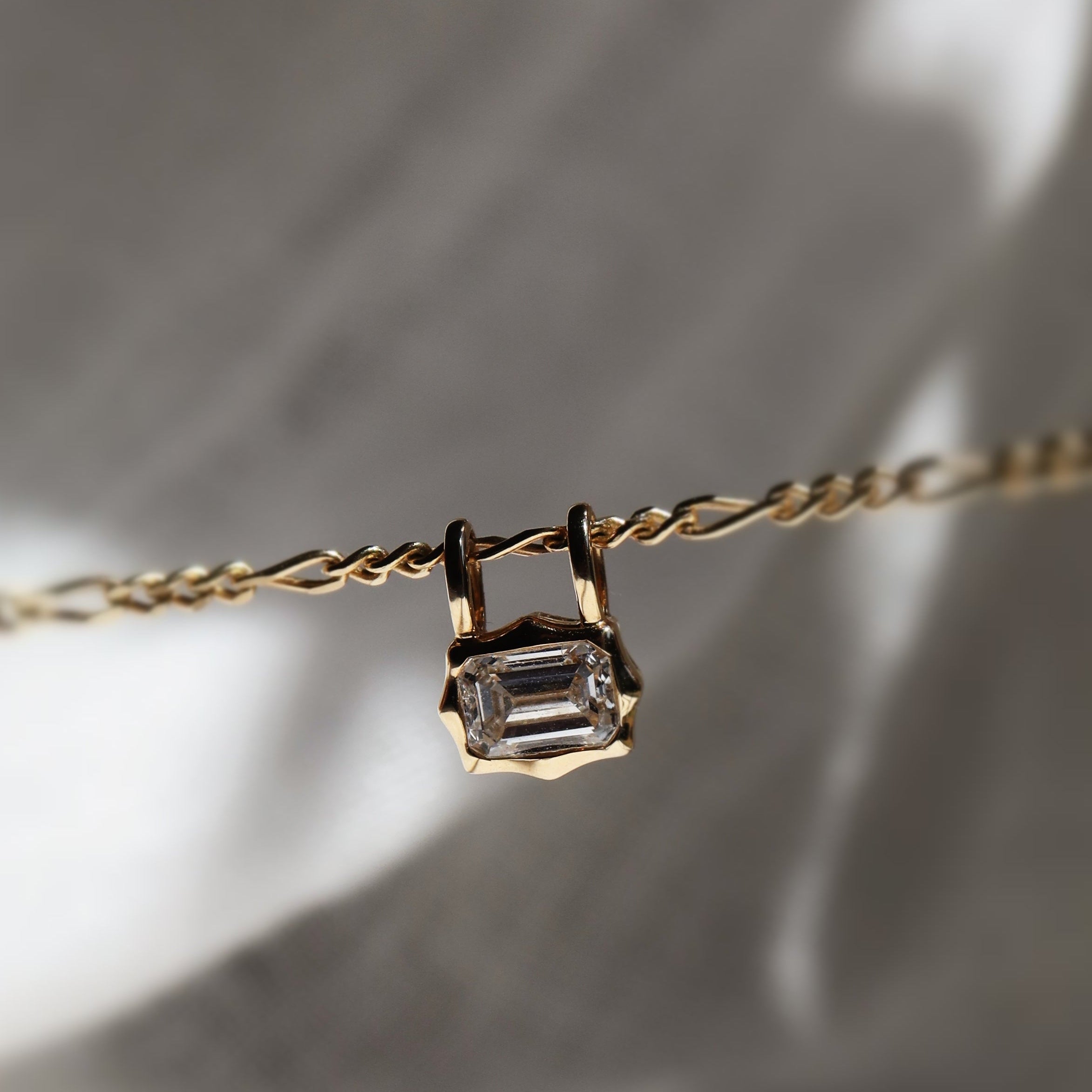emerald cut diamond bezel pendant with double loop