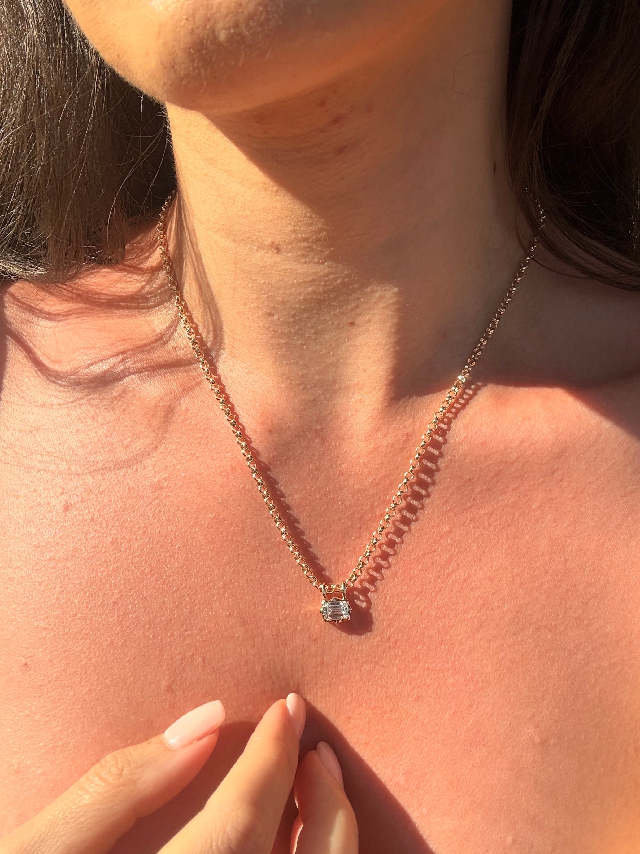 emerald cut diamond bezel pendant with double loop worn with belcher chain