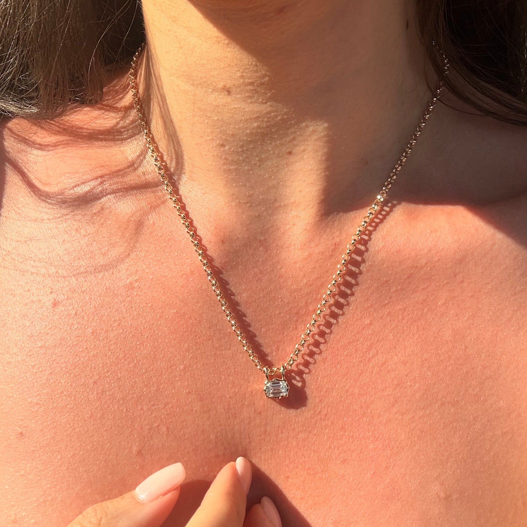 emerald cut diamond bezel pendant with double loop worn with belcher chain