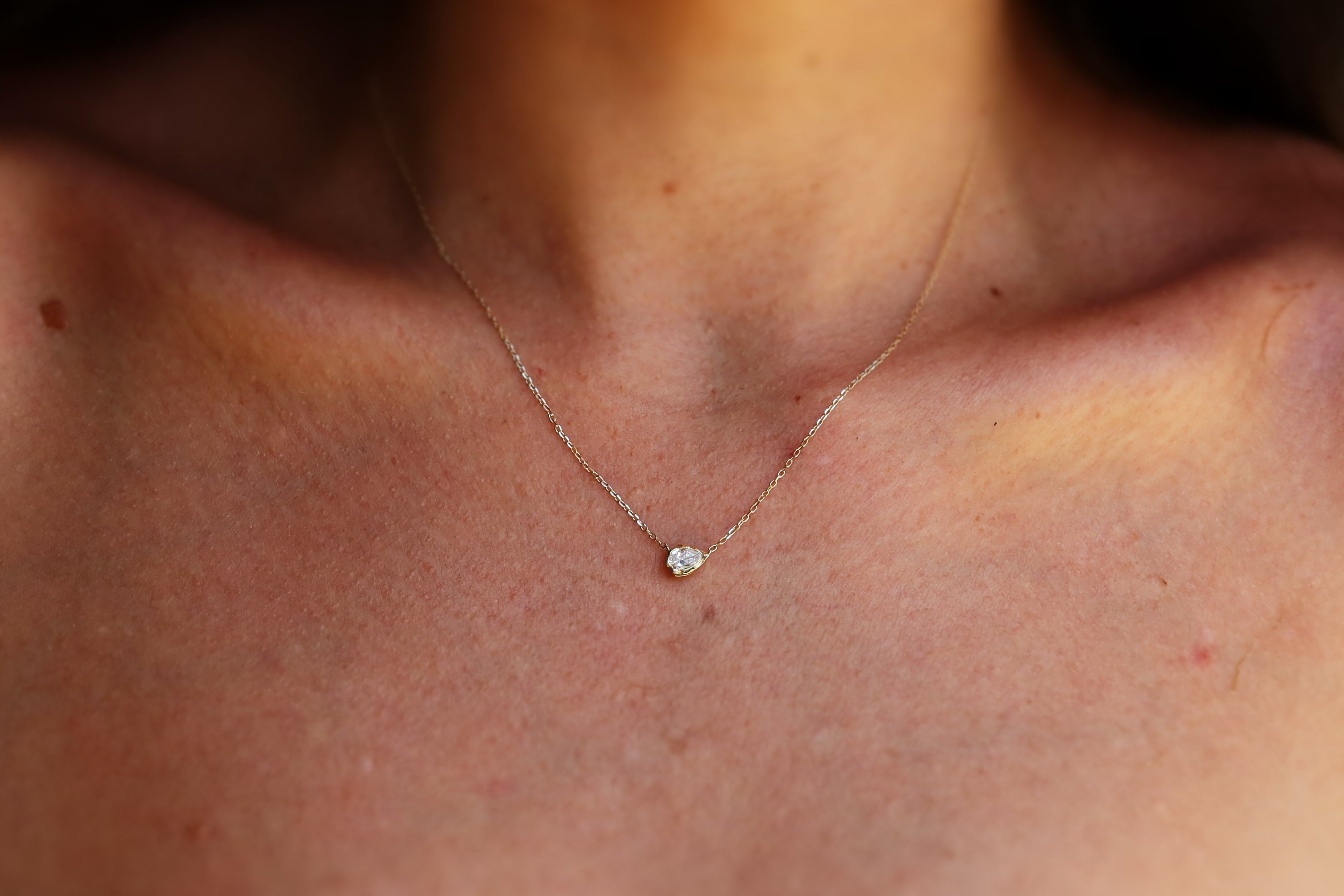melted pear diamond bezel necklace in 10 karat yellow gold