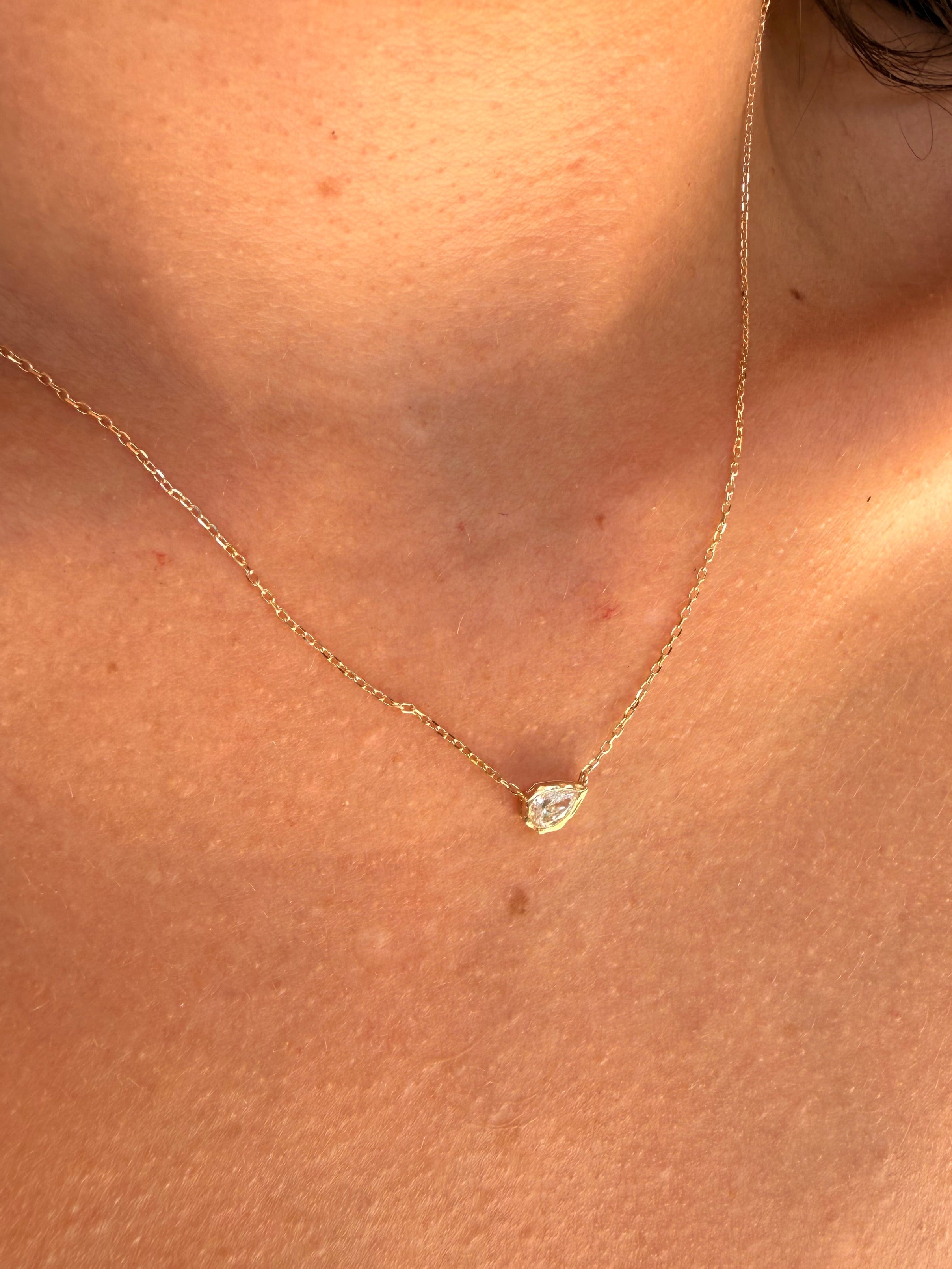 melted pear diamond bezel necklace in 10 karat yellow gold